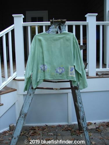Image: A green shirt on a ladder on a porch.

Alt text: 1999 Weathervane Jacket Tea Heart Spearmint Size 2, a green shirt on a ladder on a porch.