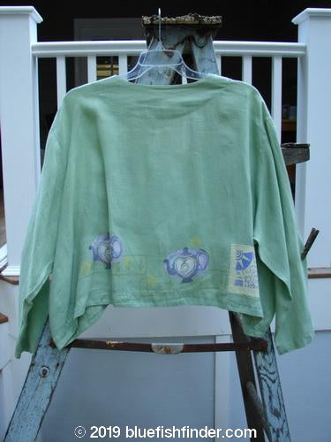 1999 Weathervane Jacket Tea Heart Spearmint Size 2: A green shirt on a swinger, featuring unique buttons, rounded side hem, and V neckline.