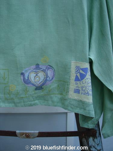 Image alt text: 1999 Weathervane Jacket with Tea and Heart Theme, Spearmint, Size 2 - Green shirt with teapot and heart design.