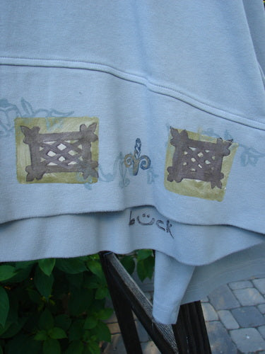 1999 Interlock Solstice Jacket: Close-up of a white shirt with wide belled sleeves, a deep V neckline, and a 2-button front.