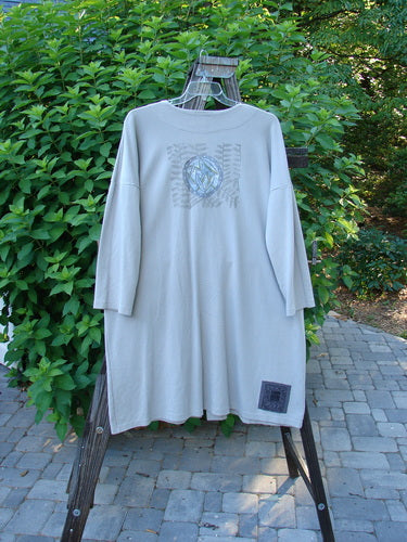 1999 Interlock Long Square Cardigan Jacket Fern Pod Ash Size 0: A long-sleeved shirt with a logo on a rack and a white towel from a rack.