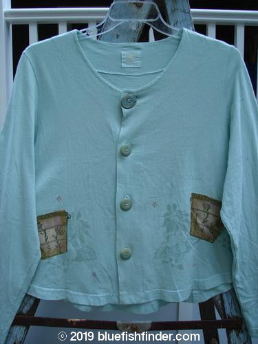 A light blue sweater with ceramic button closures and a super sweeping rounded hemline, from the 1999 Coffee Top Flowerpot Mint Size 1 collection.