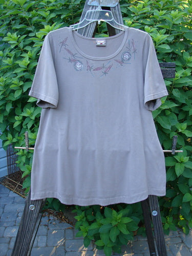 A Barclay Cotton Lycra Short Sleeved Twinkle Top in Grey Mauve, featuring a swingy hemline and a rolled scooped neckline. Size 0.