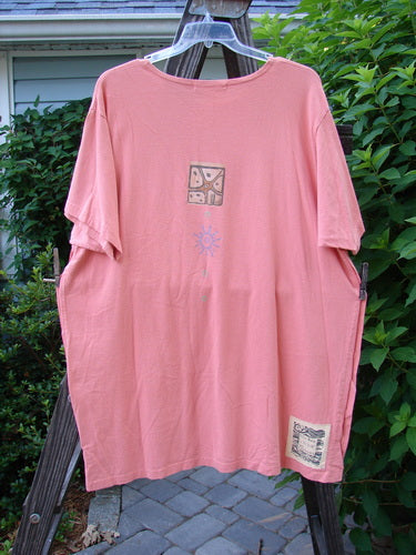 1997 Mauritius Top Fern Fish Tangerine OSFA: A pink shirt with a sun and blue sun design. Made from organic cotton, it features clear and textured floral buttons, tall side vents, and a wider longer square cut. Perfect for summer with a touch of the classic 97 fern fish theme paint.