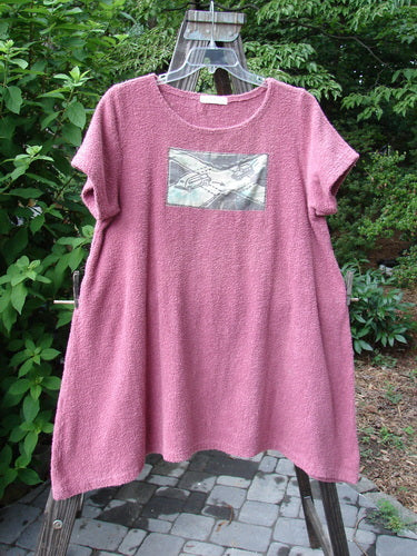 1996 Patched Shoreline Dress Skyline Hibiscus Size 2: A pink dress with skyline patches, made from thick cotton terry cloth. Features include dippy side lines, a drawcord back with metal accents, and an A-line shape.