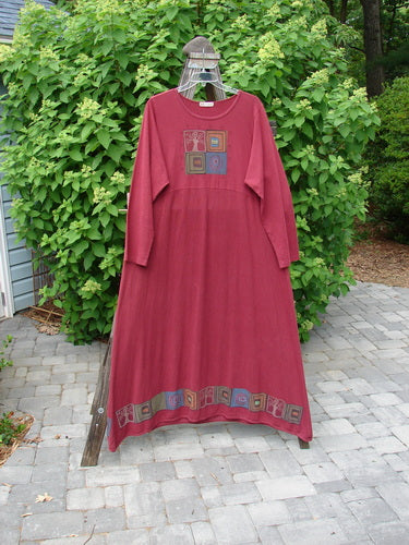 A medium weight hemp cotton Barclay Curved A Line Dress in hollyberry with a downward curved empire waist seam. Features quad theme paint with the Tree of Life theme along the hem. Size 2.