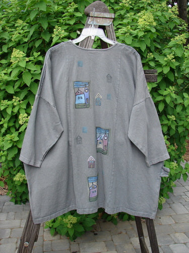 Barclay Patched Canvas Urban Tunic Top Village Grey Stone Size 2: A grey shirt with a painted design on it, featuring a split front rolled neckline, textured rectangular patch, oversized pockets, and drop shoulders.