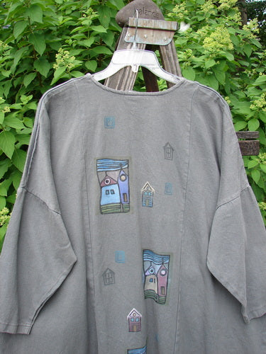 A grey Barclay Patched Canvas Urban Tunic Top with a drawing of a house on it. Features include a split front rolled neckline, oversized pockets, drop shoulders, and slightly tapered sleeves. Made from heavy weight hemp twill. Size 2.