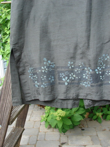 2000 Hemp Silk Sleeveless Vest with Daisy Domino print. A grey fabric with blue flowers. Features a rounded neckline and vented sides. Size 2.