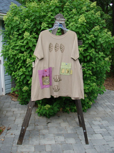 Image alt text: 1997 Montage Dress Triple Leaf Wheat Size 2: A t-shirt on a swinger with oversized colorful pockets, top button closures, and a shorter summer sleeve.