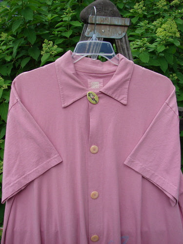 Image alt text: "1999 Tarragon Top Tulip Daisy Raspberry Size 2: A pink shirt with a deep vented sides, pleated and gathered back, and a varying hemline. Features a top porcelain button and a tiny tabbed rear accent. From the Spring II Collection of 1999 in perfect condition made from organic cotton."