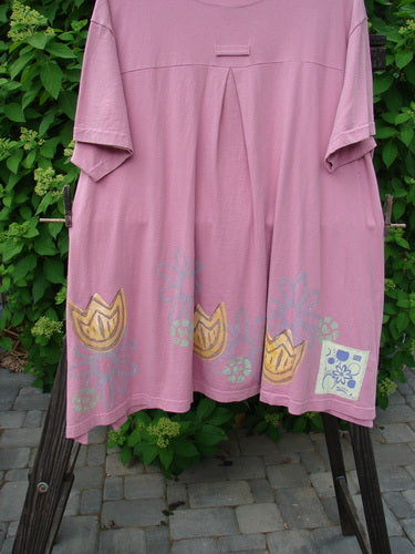 1999 Tarragon Top Tulip Daisy Raspberry Size 2: A pink shirt with a painted design on it, featuring a deep vented sides, a pleated and gathered back, and a varying hemline.