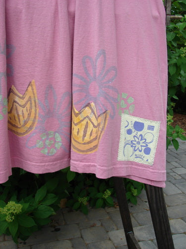 1999 Tarragon Top Tulip Daisy Raspberry Size 2: A pink fabric top with a tulip and daisy design. Features include a deep vented sides, pleated and gathered back, and a varying hemline. Perfect condition.