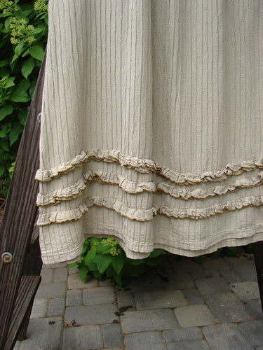 Barclay Rib Silk Triple Flutter A Line Skirt Unpainted Sand Size 2: A close-up of a flowing rib silk skirt with triple ruffle flutters, featuring a full elastic waistline and a swingy, flirty bottom.