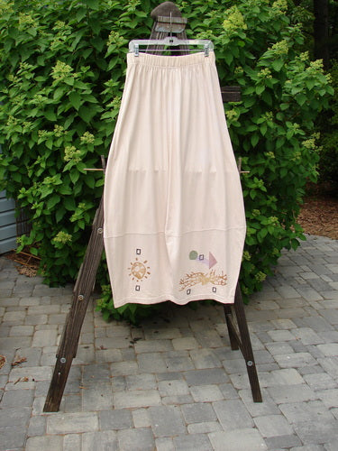 Image alt text: "1996 4 Square Skirt in Birch Bark, Size 2, on wooden rack with white dress and towel, outdoor garden setting"