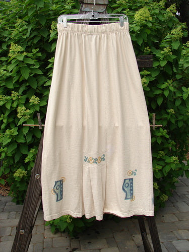 1995 Kick Skirt Resort Travel Champagne Size 2: A white skirt with a blue design, featuring a full elastic waist, elongating shape, rear kick pleat, and painted travel theme accents on the waistband.