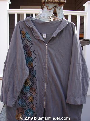 Barclay Cotton Lycra Zip Draw Back Jacket, Dusk Grey, Size 1: A grey jacket with a zipper, featuring a pointed collar, full zip front, and paneled hemline. Paneled lower sleeves and diamond-themed artwork. Bust 54, Waist 54, Hips 58, Length 36.