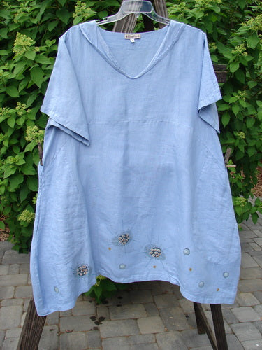 Barclay Linen Sailor Dress in Celestial Blue Sky, Size 2. A medium weight linen dress with a batiste adorned neckline, sway hemline, and empire waist seam. Features wider sleeves, drop front pockets, and celestial theme paint.