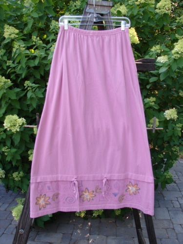 1999 Basket Skirt with Continuous Daisy design in Raspberry. Made from Medium Weight Organic Cotton. A-line flair with deep side pockets and specialized bottom. Size 0, 26" fully relaxed waist, 44" fully extended waist, 44" hips, and 38" length.