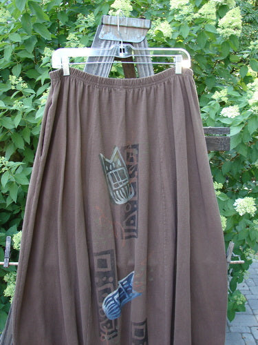 1996 Thermal Whimsical Skirt Tribal Molasses Size 2: A brown skirt with a cat design, gathered hem, and deep side pockets.