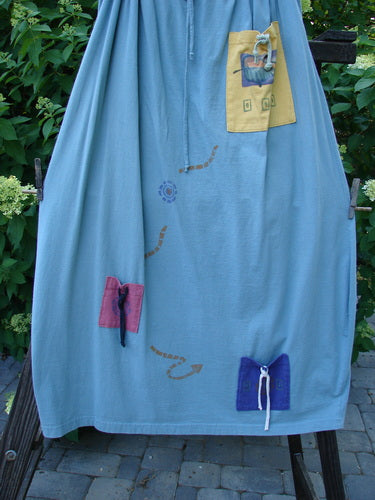1996 Destination Skirt Travel by Path Sea Spray Size 2: A blue skirt with a drawstring waist, painted pockets, and a signature Blue Fish patch. Wide bell shape with great flare.