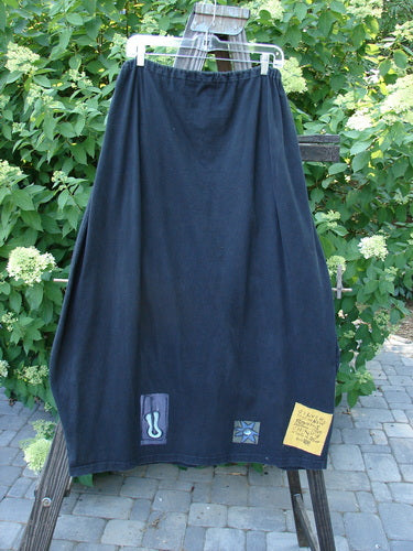 1996 Destination Skirt Blue Fish Logo Path Black Size 2: A long black skirt with a drawstring waistline, painted pockets, and a widening lower bell shape.