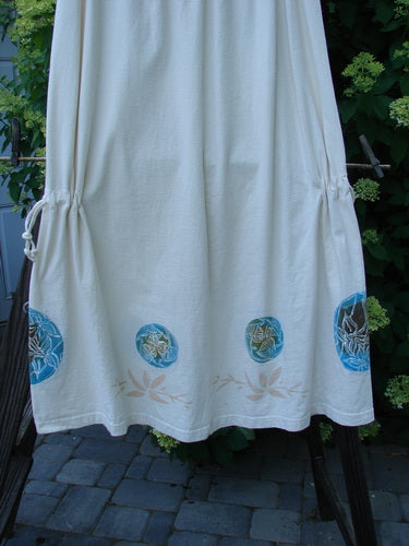1999 Tie In Skirt Leaf Medallion Natural Size 2: A white dress with blue circles on it, featuring a detailed leaf medallion theme paint.