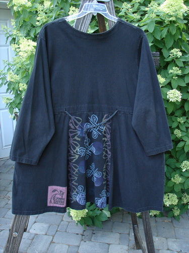 Image alt text: 1997 Jester's Dress Moon Celtic Obsidian Size 2 - A black dress with a wide swinging A-line shape, V cross-stitched neckline, and two super draw cords. Features a superior signature Blue Fish patch and continuous Celtic moon theme paint.