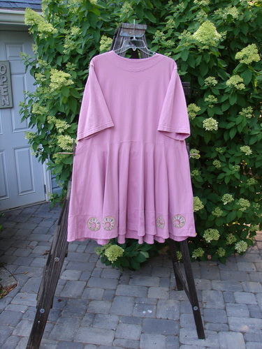 1999 Nest Dress Cherry Border Raspberry Size 2: A pink dress with a paneled neck, short springy sleeves, and a swingy lower. Perfect condition, made from organic cotton.