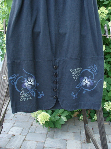 1997 Indra Skirt with whimsical florals in obsidian. Full elastic waistline, double paneled lower, colorful chiseled buttons, deep side pockets, and superior vents with loop closures. Made from mid-weight organic cotton. Size 2.