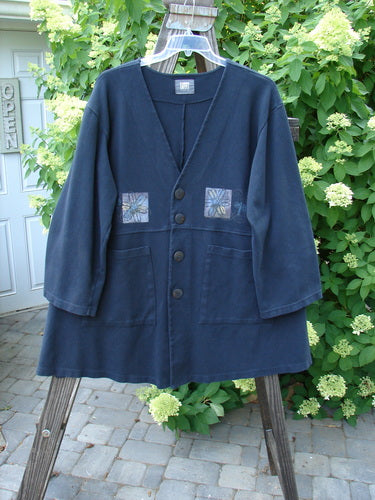 1999 Interlock Stellar Jacket Celtic Flower Black Size 0: A blue jacket with patchwork designs and metallic holiday Celtic flower theme paint. Features include large front pockets, vented sides, and oversized buttons.