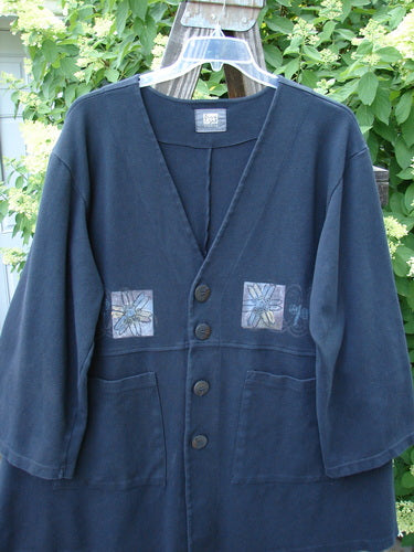 1999 Interlock Stellar Jacket Celtic Flower Black Size 0: A blue jacket with a patch, detailed metallic holiday Celtic flower theme paint, large front pockets, vented sides, oversized front buttons, bell sleeves, and a double paneled button line.