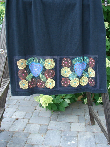 A 1999 Straight Skirt with bright mosaic florals on a black background. Made from organic cotton, this skirt features a full elastic waistline and a slight A-line flare. Perfect condition. Size 2.