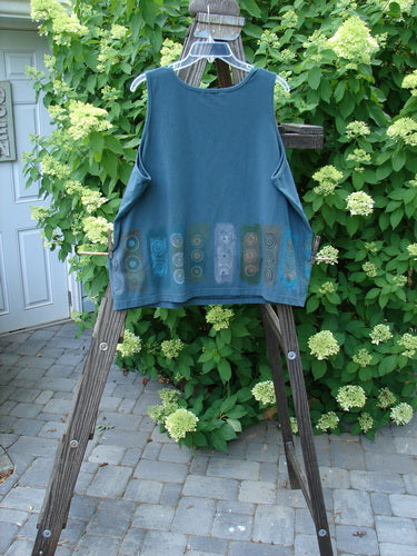 A blue Barclay Cotton Lycra Summer Tank on a wooden ladder, showcasing its lovely medium weight and straight, slightly tapered lower shape.