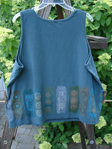 A blue shirt with a pattern on it, part of the Barclay Cotton Lycra Summer Tank Collection in Puddle. Features a round neckline, tapered shape, and medium weight. Made from organic cotton and lycra. Size 1.