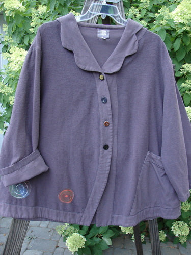 2000 Patched Frolic Jacket with Pinwheel Patches, size 2, in eggplant flannel. Cropped, scalloped neckline, split rounded hemline, unique buttons.