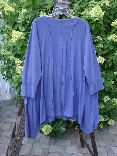 Image: A blue shirt on a swinger. 

Alt text: Barclay Hemp Cotton Two Tier Sectional Jacket in Bloomsberry, Size 2. Swingy side inserts, exterior stitchery, cuff-able lower sleeves, and sectional panels.