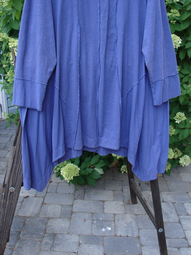 Image alt text: Barclay Hemp Cotton Two Tier Sectional Jacket on a rack, featuring swingy side inserts, exterior stitchery, and cuff-able lower sleeves.
