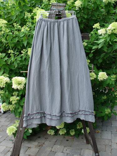 Barclay Rib Silk Double Flutter A Line Skirt Unpainted Silver Gray Size 2: A skirt on a rack, featuring a full elastic waistline, double ruffle flutter, and a silken vertical texture.