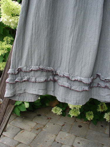 Barclay Rib Silk Double Flutter A Line Skirt Unpainted Silver Gray Size 2: Close-up of a flowing rib silk skirt with a double ruffle flutter, elastic waistline, and swingy flirty bottom.
