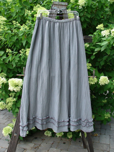 Barclay Rib Silk Double Flutter A Line Skirt Unpainted Silver Gray Size 2: A skirt on a rack, featuring a full elastic waistline, a super swingy flirty bottom with a continuous double ruffle flutter, and a silken vertical texture.
