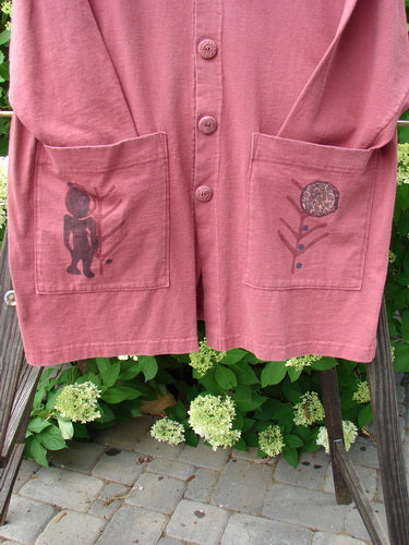 1996 Elements Everyday Jacket Primitive World Ember Size 1: A pink shirt with a drawing on it, featuring a longer narrowing shape, scribe buttons, oversized painted drop pockets, and a Blue Fish patch.