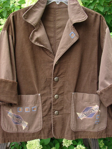A 1997 Mason's Jacket in Lumber, featuring folded neckline, painted pockets, cuffed cord sleeves, and metal buttons.