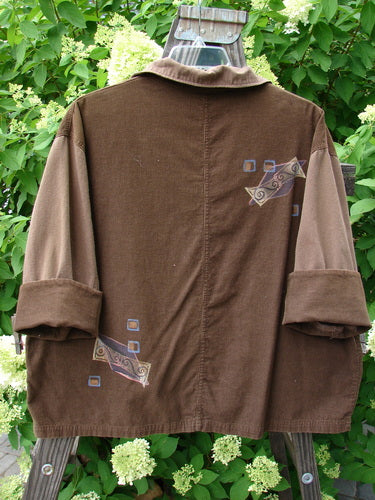 1997 Mason's Jacket in Lumber, OSFA: Brown corduroy jacket with patch, folded neckline, painted pockets, and metal buttons.
