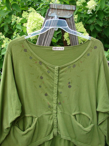 A yellow olive Barclay Snap Off Jacket with front snaps, oval flop pockets, boatneck line, and varying hemline, made from medium weight organic cotton. Size 0.