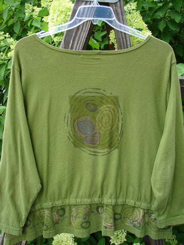 Image alt text: "Barclay Snap Off Jacket Wind Yellow Olive Size 0: Green shirt with a design and pattern, featuring front snaps, oval front entry flop pockets, boatneck line, and varying upward scooped hemline."