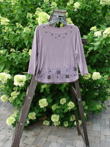 A lavender Barclay Cotton Lycra Round Hem Layering Top with a patterned purple shirt on a wooden stand.