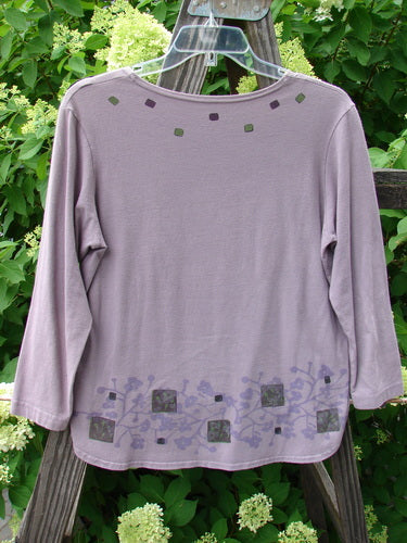 Barclay Cotton Lycra Round Hem Layering Top Berry Lavender Size 1: A purple shirt with a design on it, featuring a rounded hemline and three-quarter length sleeves.