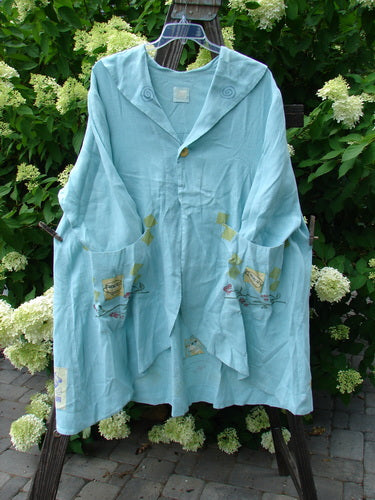 Image alt text: "1999 Breeze Jacket with cherry and teatime theme paint, oversized drop front pockets, and a swing silhouette on a clothes rack"
