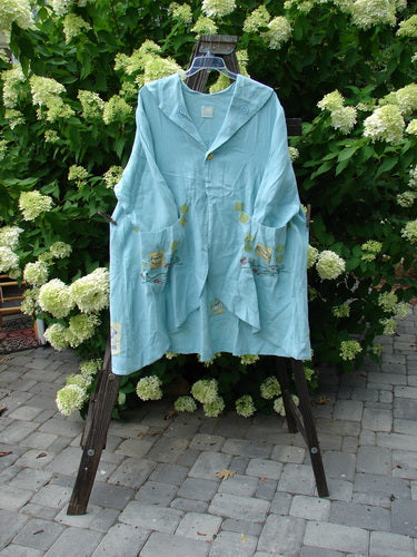 Image: A blue shirt with pockets on a clothes line.

Alt text: 1999 Breeze Jacket Cherry Tea Time Spring OSFA - Blue shirt with pockets hanging on a clothes line.